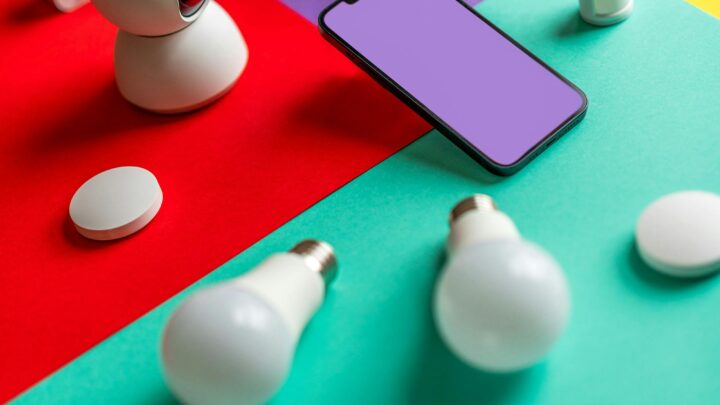 Modern smart home gadgets displayed on a colorful abstract background with vibrant lighting.